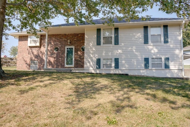 split foyer home with a front lawn