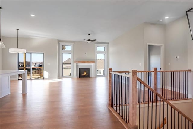 unfurnished living room featuring wood-type flooring and ceiling fan