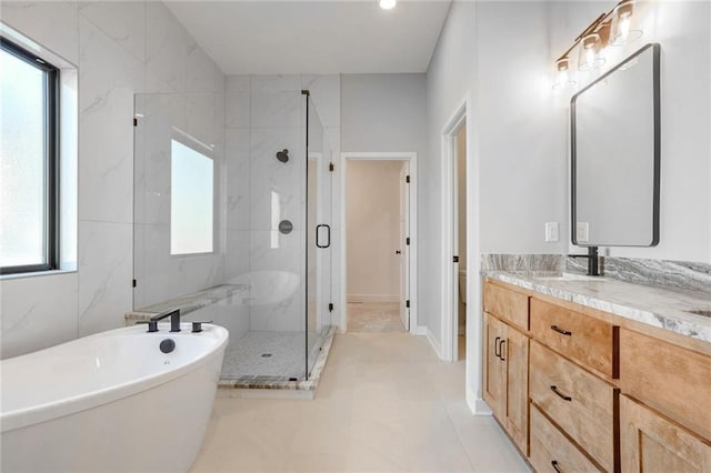 full bathroom with tile patterned floors, vanity, a healthy amount of sunlight, and plus walk in shower