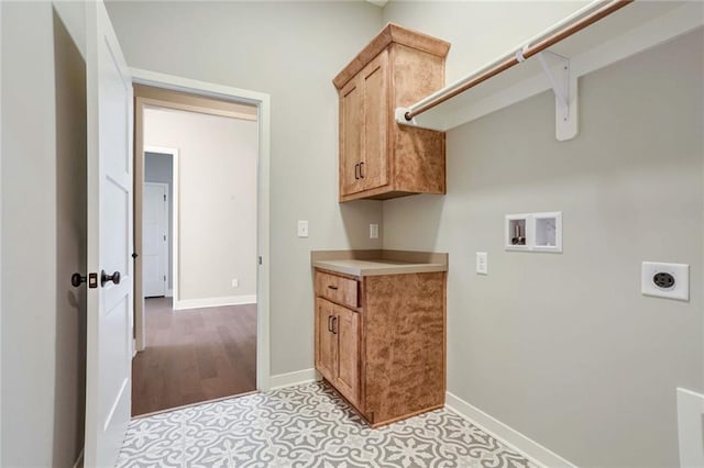 laundry room with electric dryer hookup, cabinets, and washer hookup