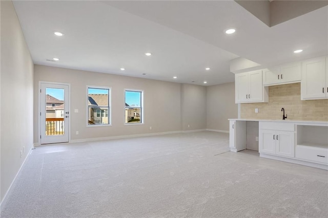 interior space with sink and light carpet