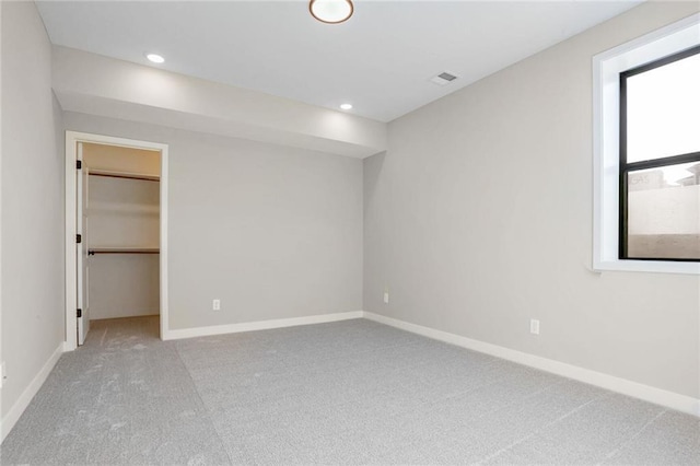 7090 NW Forest Lakes Dr, Parkville, MO 64152 - unfurnished bedroom with carpet flooring, a walk in closet, and recessed lighting