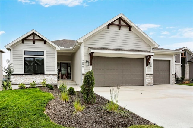 7090 NW Forest Lakes Dr, Parkville, MO 64152 - view of front of property featuring a garage, driveway, and stone siding