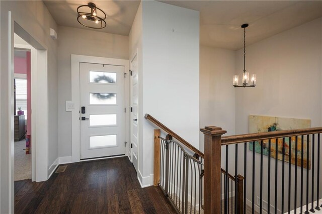 entrance foyer featuring a notable chandelier and dark hardwood / wood-style floors