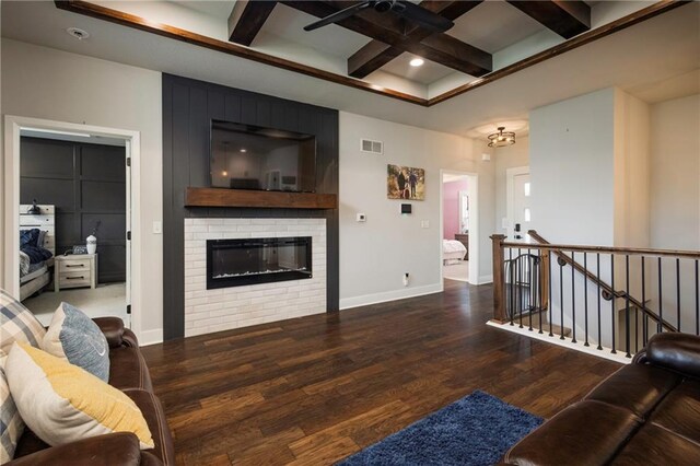 living room with coffered ceiling, beam ceiling, dark hardwood / wood-style flooring, and a brick fireplace