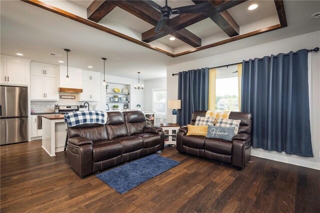 living room featuring coffered ceiling, beamed ceiling, ceiling fan with notable chandelier, and dark hardwood / wood-style flooring