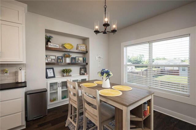 dining room featuring dark wood-type flooring and a notable chandelier