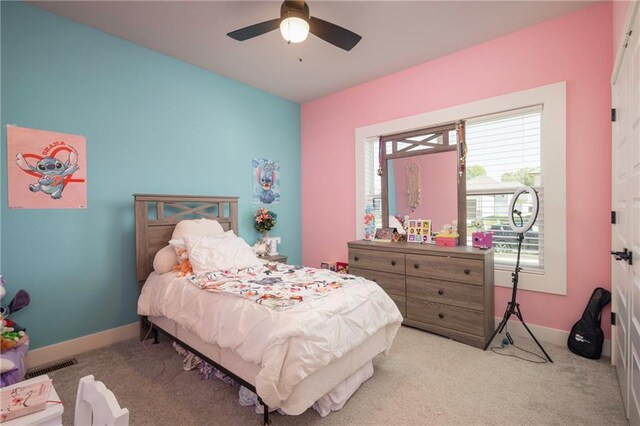 bedroom with ceiling fan and light carpet