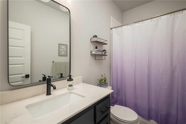 bathroom with vanity, toilet, and a shower with curtain