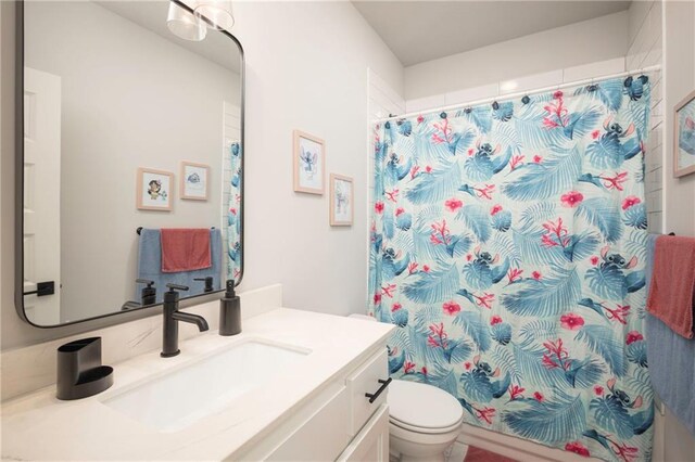 bathroom featuring vanity, toilet, and a shower with curtain