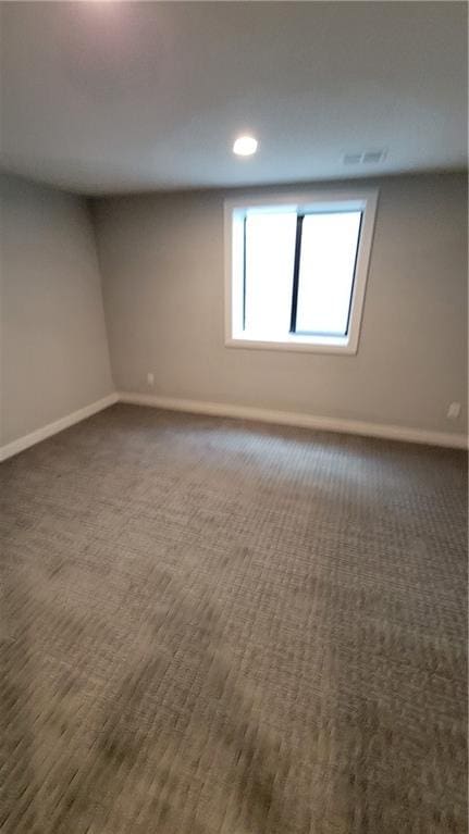 empty room featuring dark colored carpet