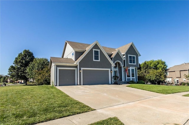 view of front of house with a garage and a front lawn