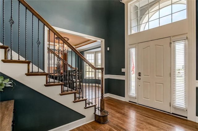 entrance foyer with wood-type flooring and a notable chandelier