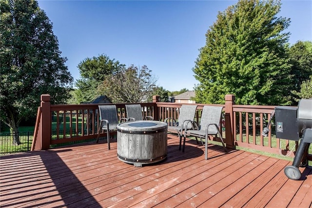 wooden terrace with a grill