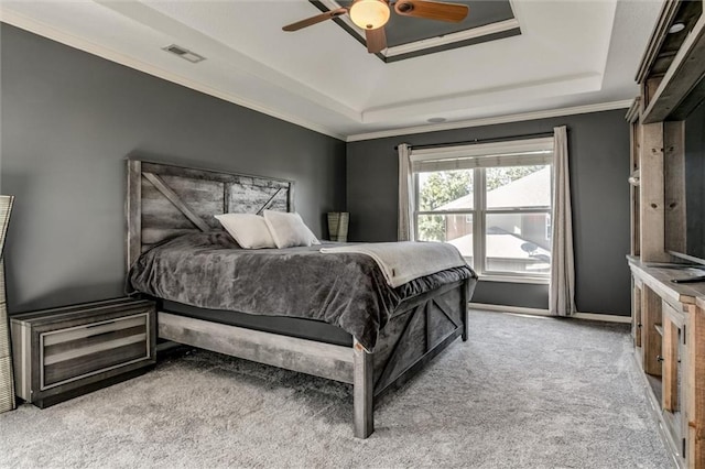 bedroom featuring light carpet, ceiling fan, a raised ceiling, and crown molding