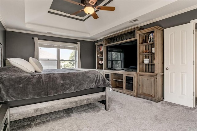 bedroom with a raised ceiling, carpet flooring, crown molding, and ceiling fan