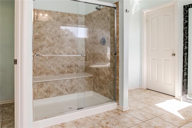 bathroom with tile patterned floors and a shower with shower door