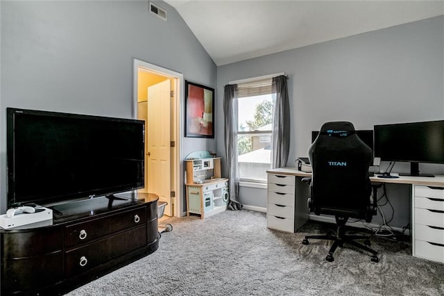 carpeted office with lofted ceiling