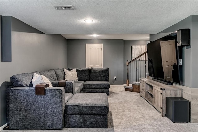 carpeted living room with a textured ceiling