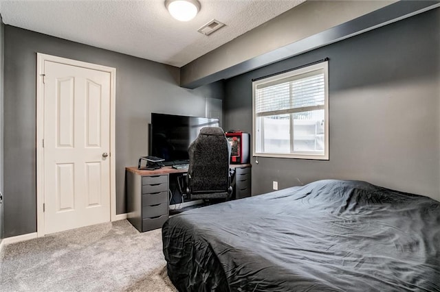 bedroom with carpet and a textured ceiling