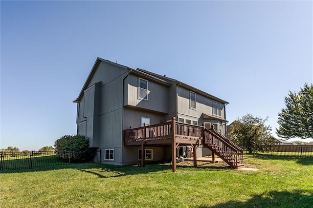 rear view of property with a lawn and a wooden deck