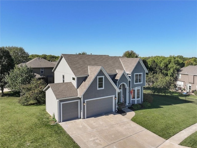 view of front of property featuring a front yard and a garage