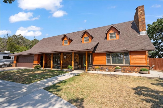 cape cod-style house with a garage and a front lawn