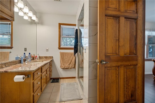 bathroom featuring plenty of natural light, hardwood / wood-style floors, vanity, and walk in shower