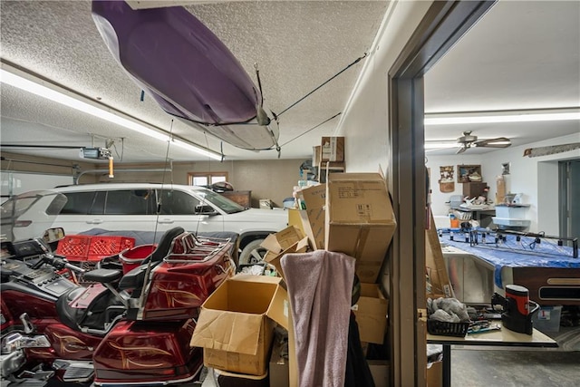 garage with a garage door opener and ceiling fan