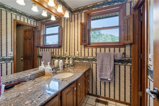 bathroom featuring tile patterned floors, a healthy amount of sunlight, and vanity