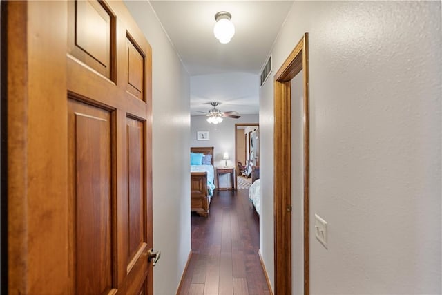 hallway with dark hardwood / wood-style flooring