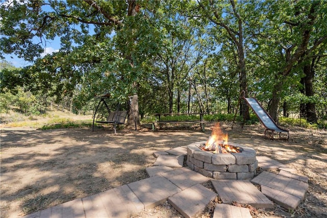 view of yard with an outdoor fire pit