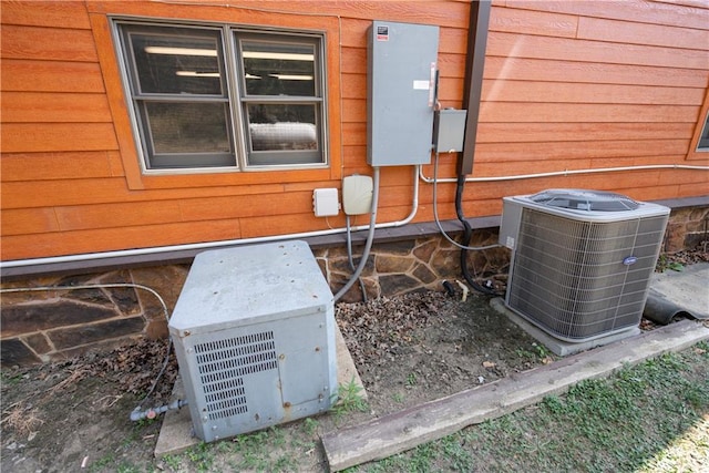 details with cooling unit, ac unit, and wooden walls