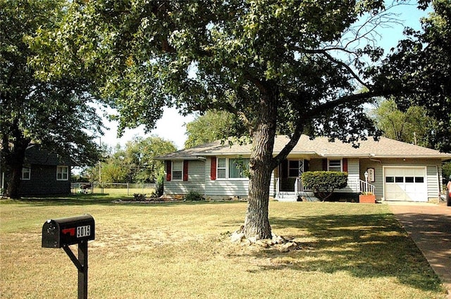 ranch-style home with a garage and a front lawn