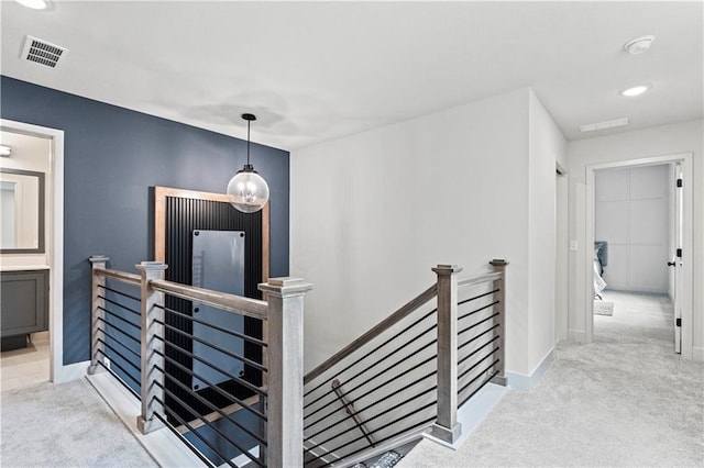 corridor with light colored carpet