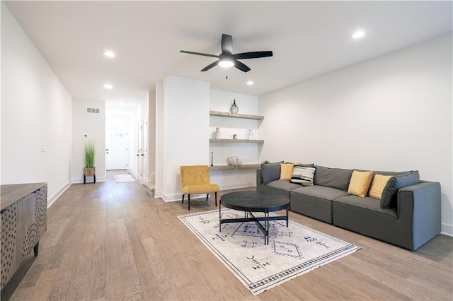 living room featuring light hardwood / wood-style floors and ceiling fan