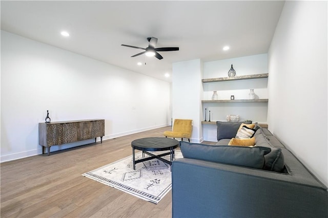 living room featuring ceiling fan and wood-type flooring