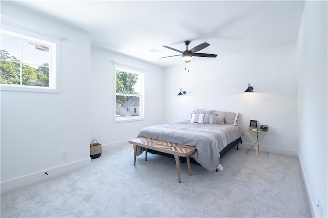 bedroom with ceiling fan and light colored carpet