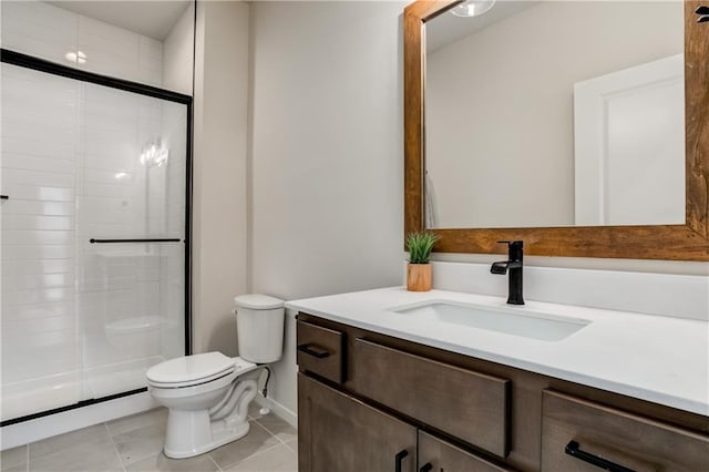 bathroom with tile patterned flooring, vanity, toilet, and an enclosed shower