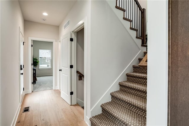 stairs with wood-type flooring