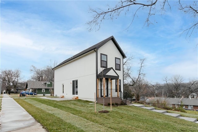 view of side of home with a yard