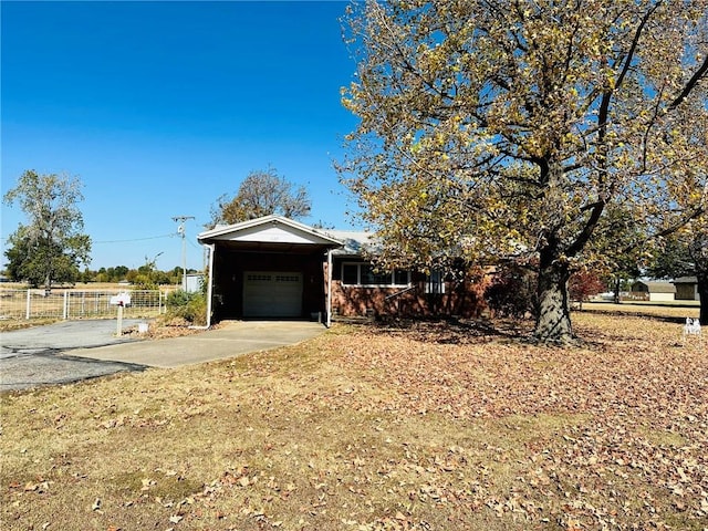 view of front facade featuring a garage and a carport