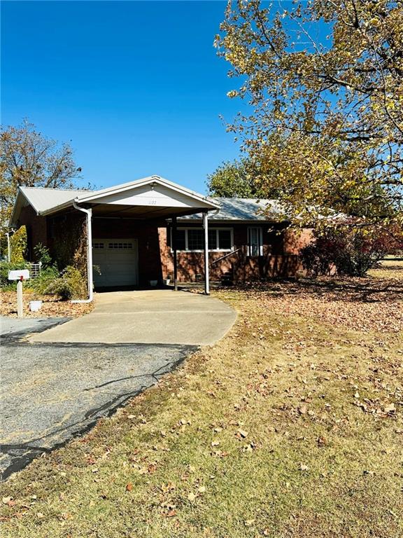 ranch-style house with a carport and a garage