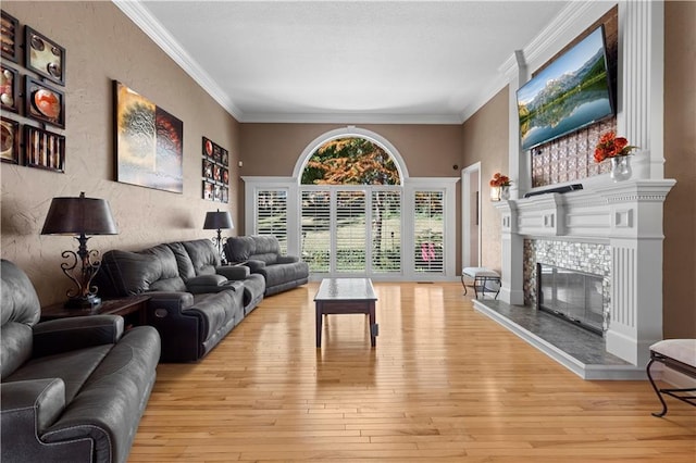 living room featuring crown molding and light hardwood / wood-style flooring