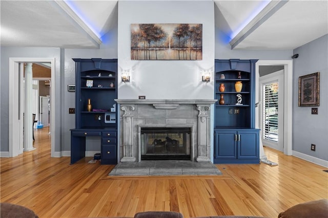 unfurnished living room featuring hardwood / wood-style flooring and vaulted ceiling