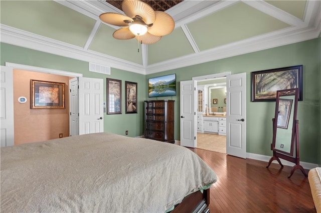 bedroom featuring ceiling fan, hardwood / wood-style flooring, connected bathroom, and ornamental molding