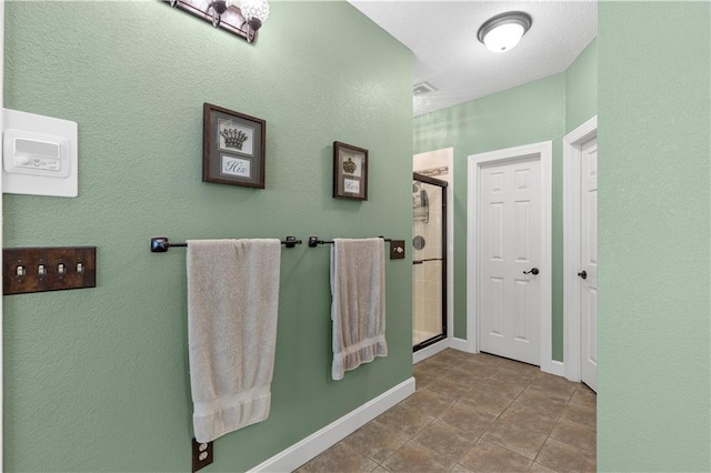 bathroom with tile patterned flooring and an enclosed shower