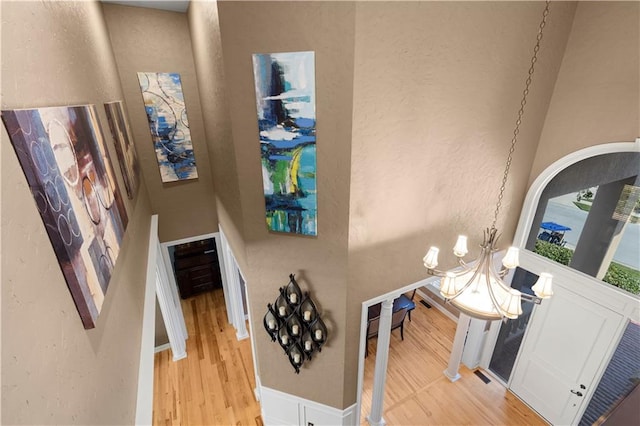 entrance foyer with a notable chandelier and light wood-type flooring