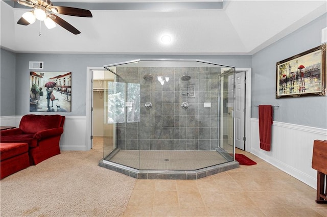 bathroom with a shower with door and ceiling fan