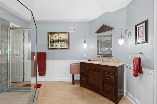 bathroom with tile patterned floors, an enclosed shower, and vanity